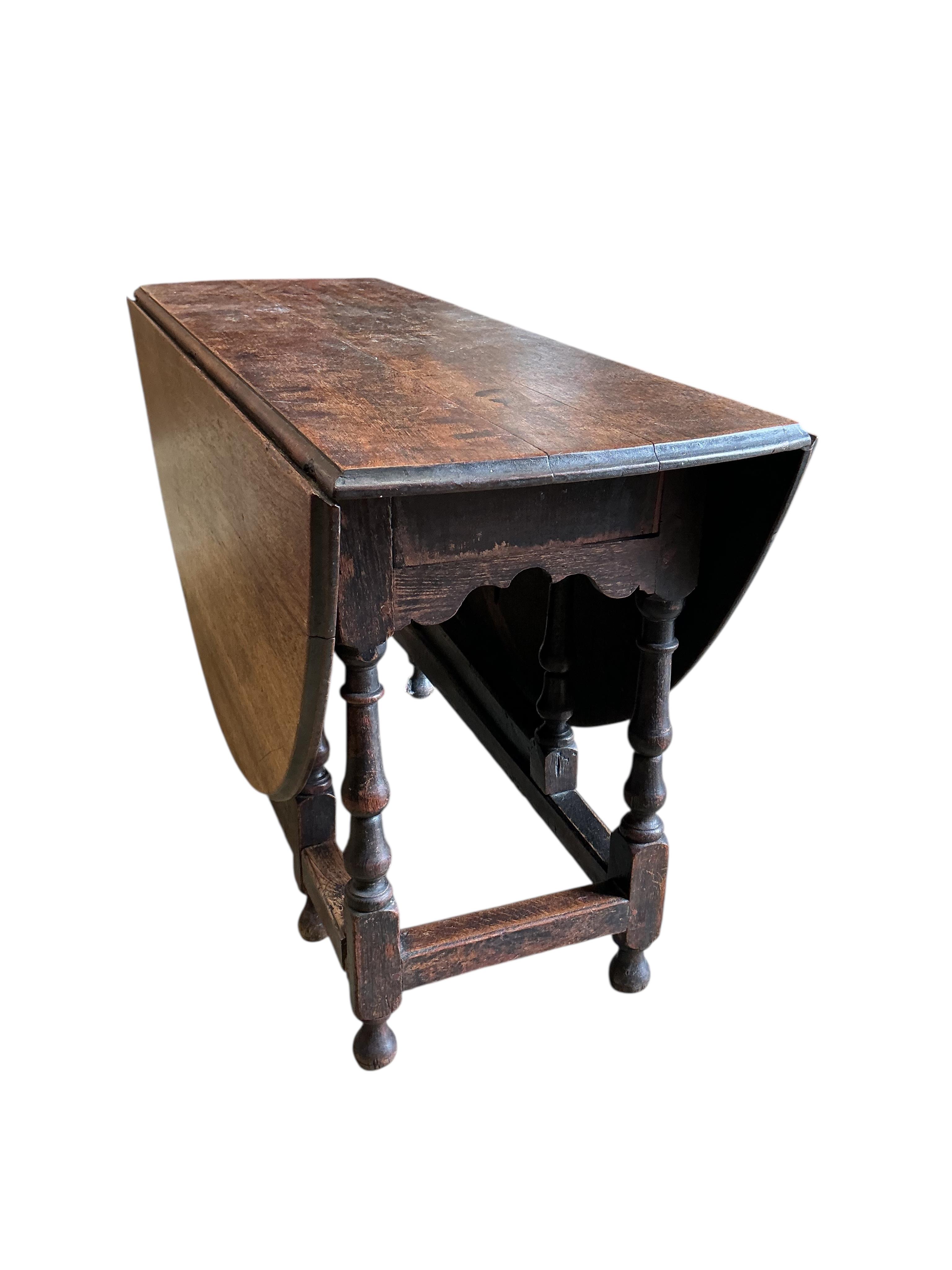 An 18th century oak gateleg table, width 130cm, depth 49cm, height 73cm